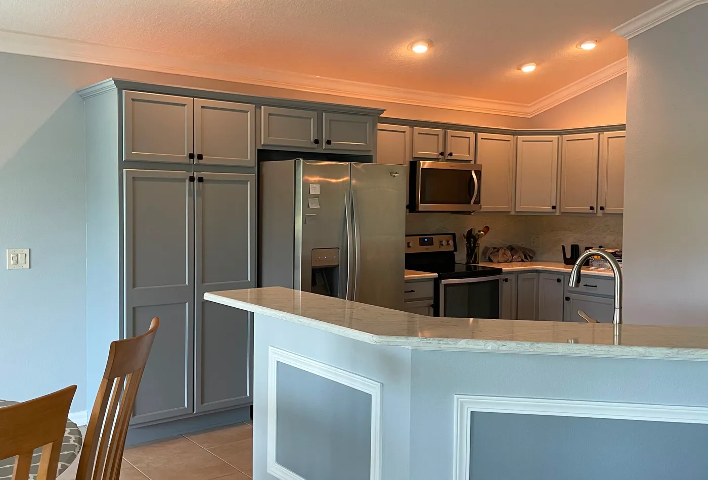 Gray kitchen cabinet painting project with a smooth updated finish