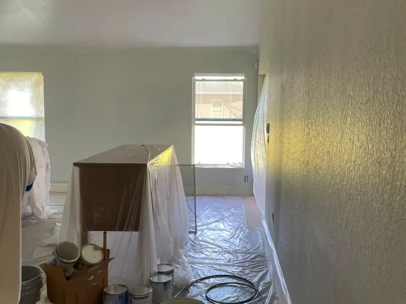 Interior painting in progress with spray application