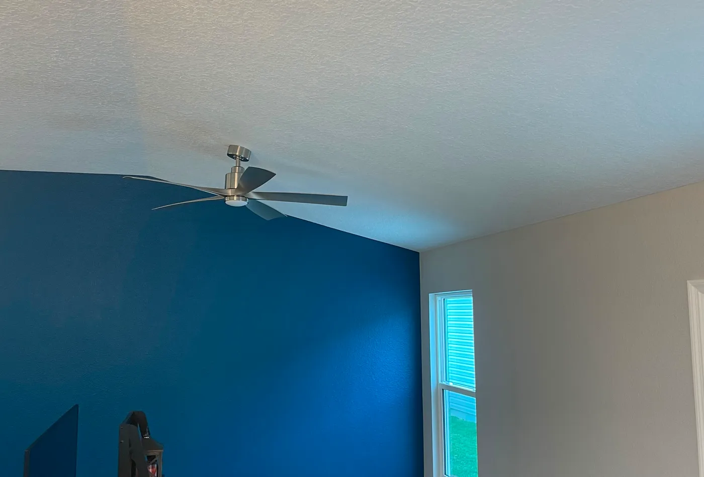 Navy blue accent wall in a freshly painted living room