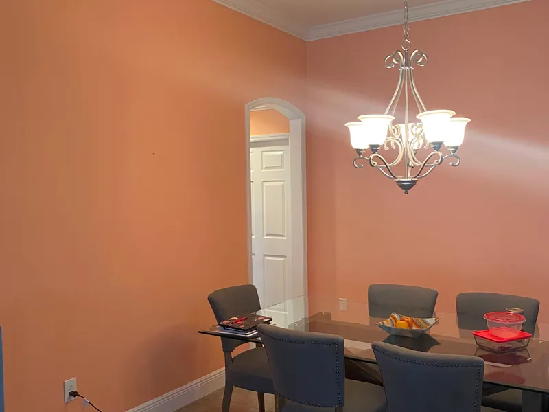 Orange dining room interior repaint with crisp wall finish